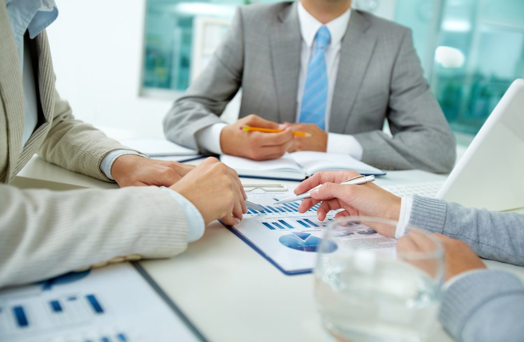 three businessmen looking at a cloud consulting proposal