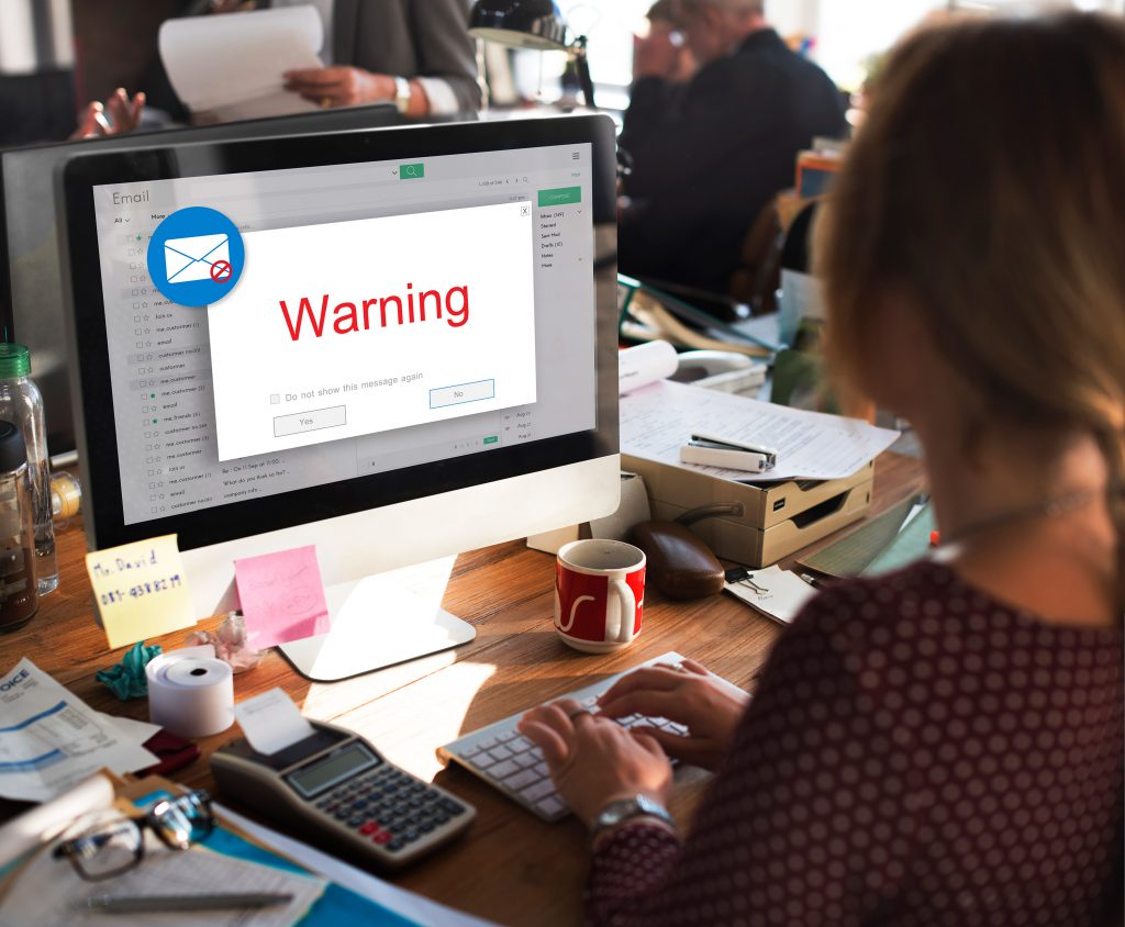 office computer with email warning of cybersecurity threat